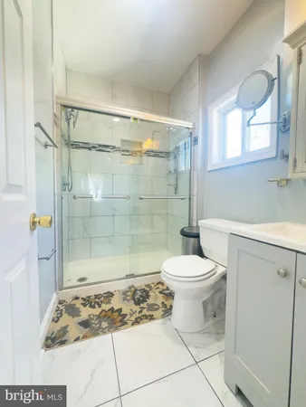 a bathroom with a toilet and a shower