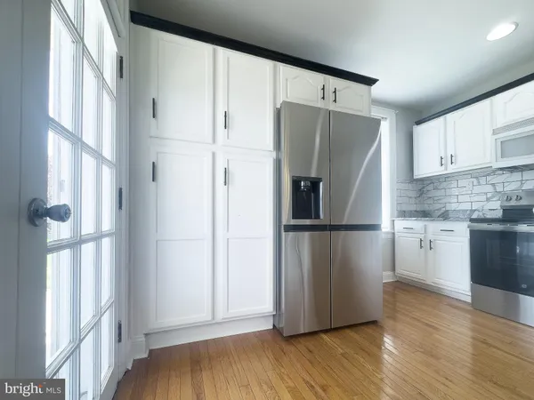a kitchen with stainless steel appliances a refrigerator and a window