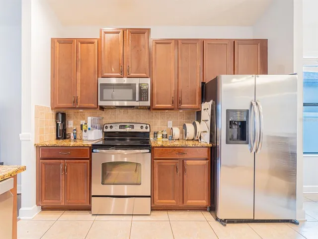 a kitchen with a stove refrigerator and cabinets