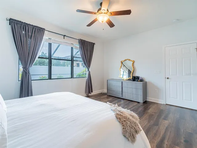 a bedroom with a large bed and a window