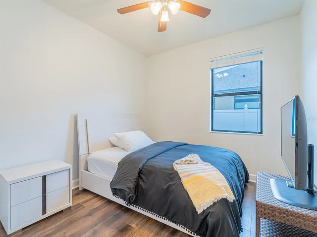 a bedroom with a bed and a chandelier
