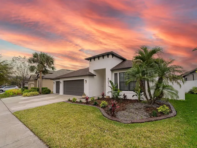 a view of a house with a swimming pool and a yard