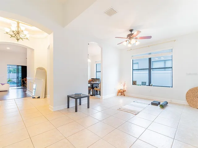 a living room with furniture and a chandelier
