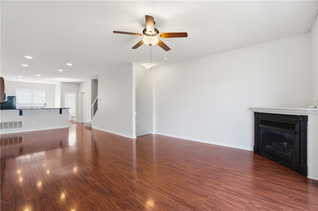 4294 Straight Arrow Road Dayton, OH 45430 - Photo 10 of 41 Bright open-concept living space with lustrous hardwood floors and a cozy fireplace.