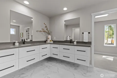 a bathroom with double sink and a mirror