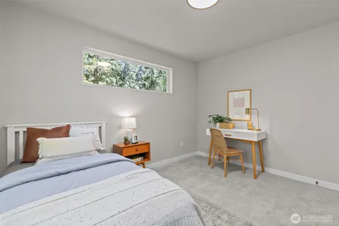 a bedroom with a bed and a table in it