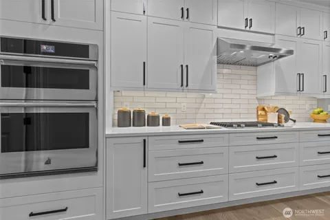 a kitchen with stainless steel appliances and cabinets