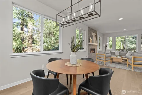 a dining room with furniture a chandelier and wooden floor