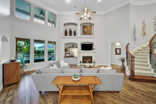 a living room with furniture fireplace and wooden floor