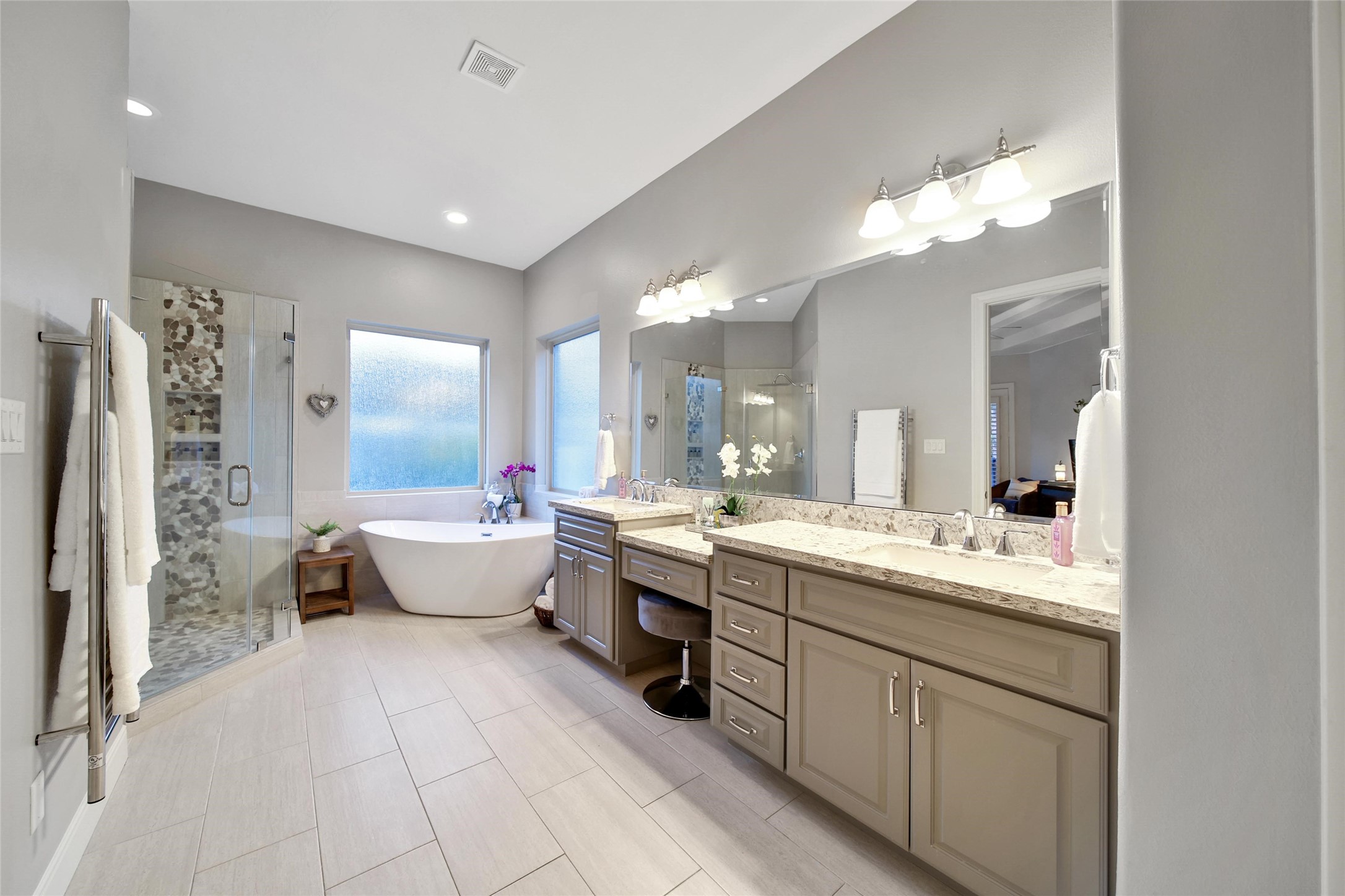 5902 Royal Hill Court Kingwood, TX 77345 - Photo 15 of 43 a large bathroom with a double vanity sink a large mirror and a bathtub