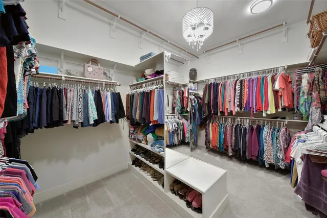 a view of walk in closet with clothes