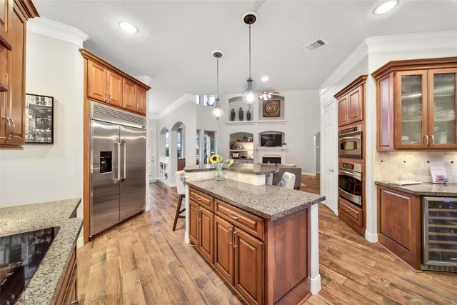 a kitchen with stainless steel appliances granite countertop a sink stove and refrigerator