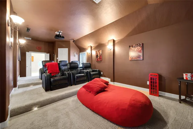 a living room with furniture gym equipment and a chandelier