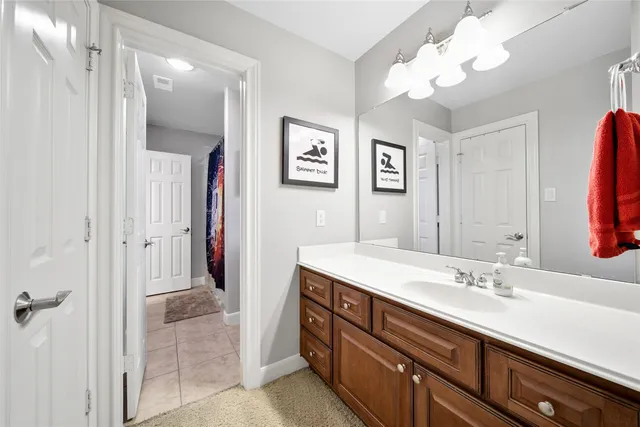 a spacious bathroom with a granite countertop sink a mirror a light fixture and a window