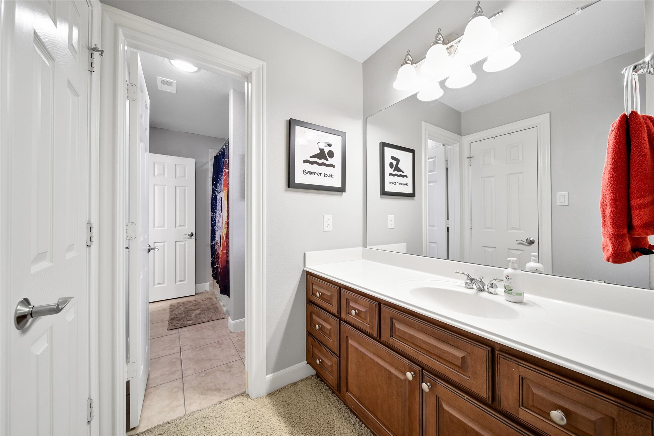 5902 Royal Hill Court Kingwood, TX 77345 - Photo 34 of 43 a spacious bathroom with a granite countertop sink a mirror a light fixture and a window