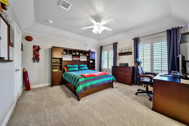 a bedroom that has a bed and a chandelier