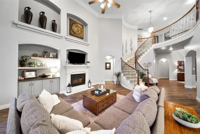 a living room with furniture a fireplace and a chandelier