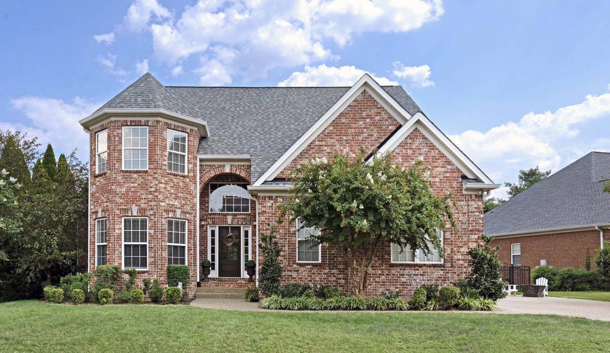 a front view of a house with garden