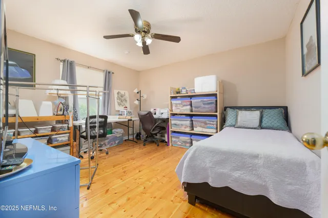 a spacious bedroom with a bed couch and a large window