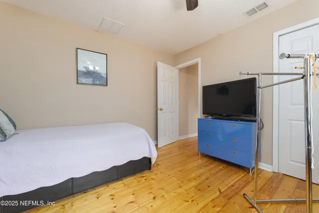 a bedroom with a bed and ceiling fan