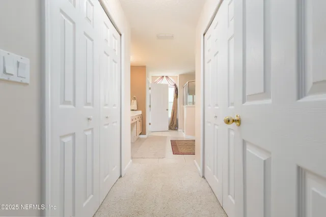 a spacious bathroom with a double vanity sink mirror and shower