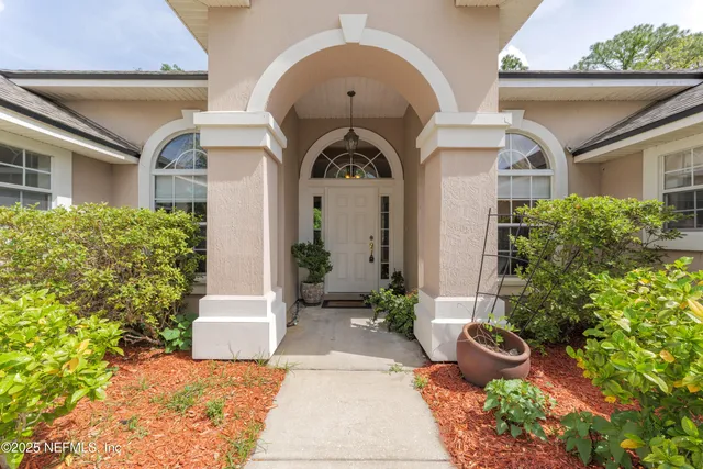 a view of an outdoor dining space with a table and chairs