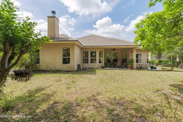 an aerial view of residential house with outdoor space and swimming pool