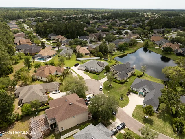an aerial view of a house with a yard