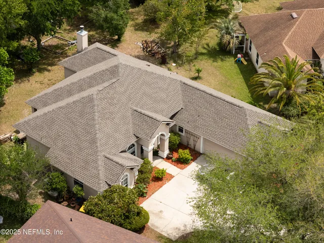 an aerial view of residential houses with outdoor space