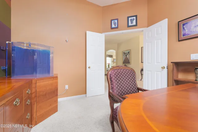 a view of a dining room and hall with furniture