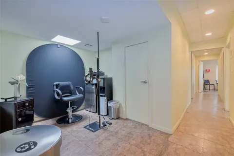 a view of a workspace with furniture and a window