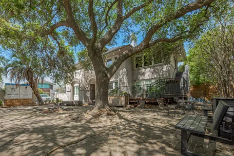 a backyard of a house with table and chairs