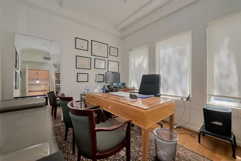 a view of a dining room with furniture and a potted plant