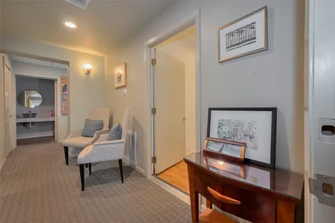 a living room with furniture and a painting on the wall