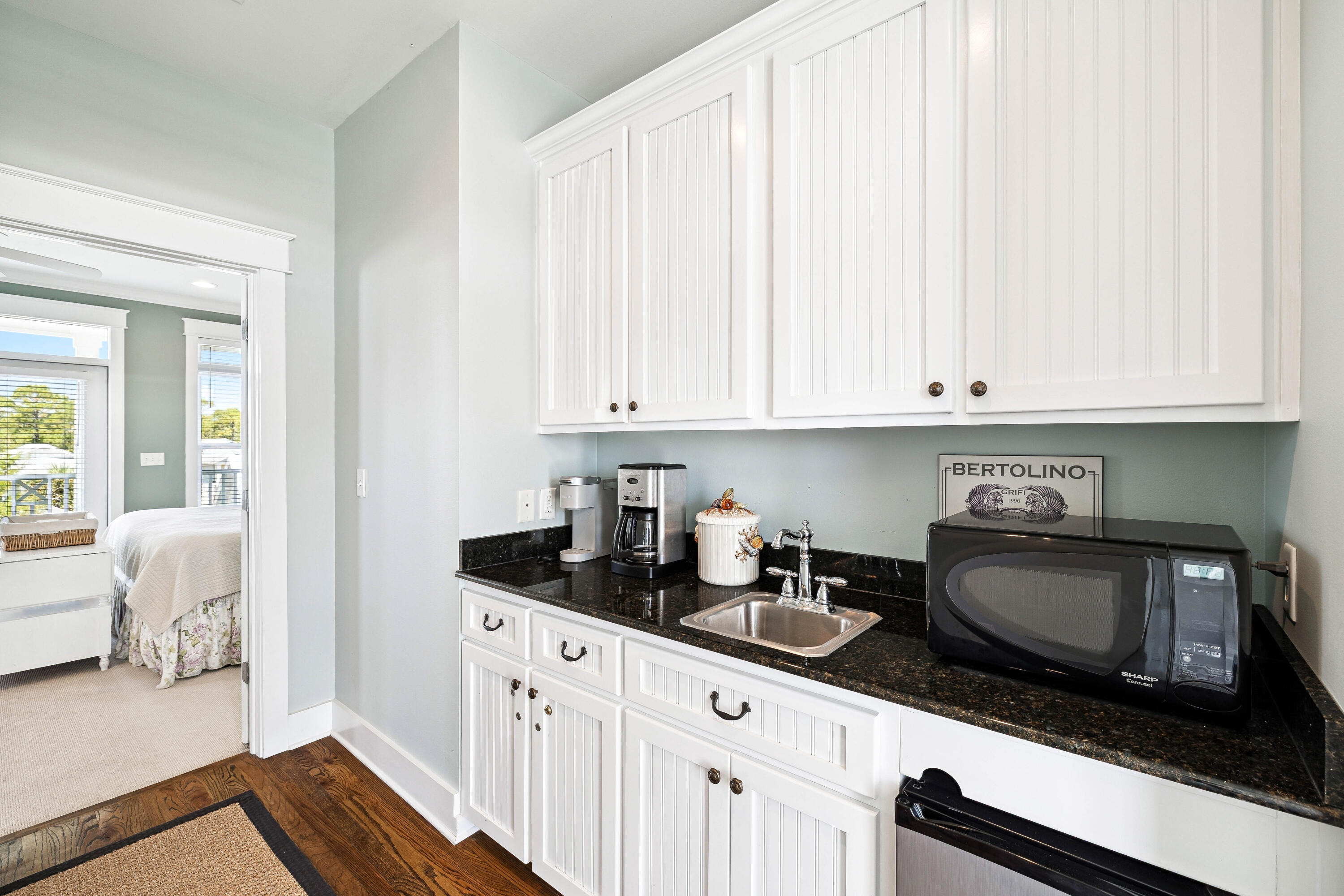 54 Surfer Lane Seacrest, FL 32461 - Photo 37 of 47 a kitchen with granite countertop white cabinets and sink