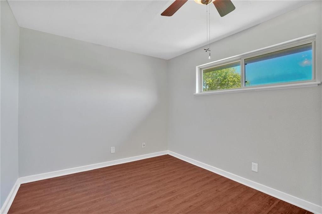 2000 Lightsey Road, Unit 1 Austin, TX 78704 - Photo 13 of 19 a view of an empty room with a window and wooden floor