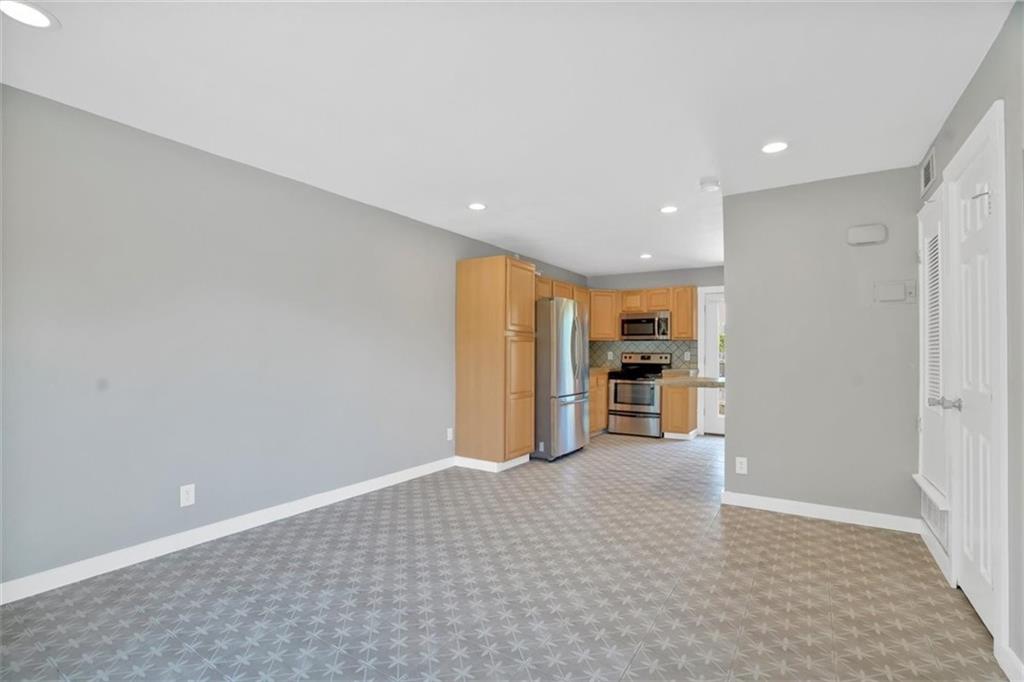 2000 Lightsey Road, Unit 1 Austin, TX 78704 - Photo 5 of 19 a view of a kitchen with a sink and a refrigerator