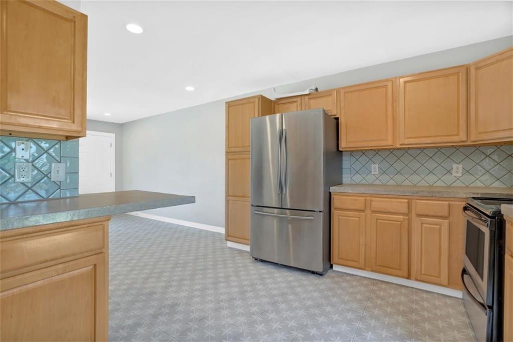 2000 Lightsey Road, Unit 1 Austin, TX 78704 - Photo 9 of 19 a kitchen with cabinets and stainless steel appliances