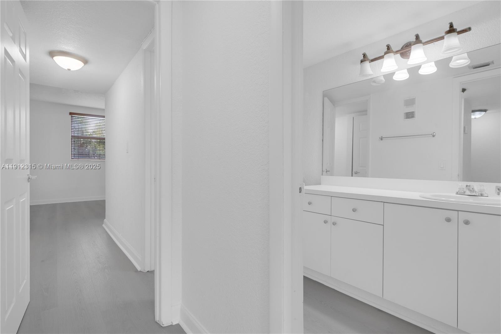 10900 Southwest 104th Street, Unit 121 Miami, FL 33176 - Photo 17 of 34 a bathroom with a sink mirror and a vanity