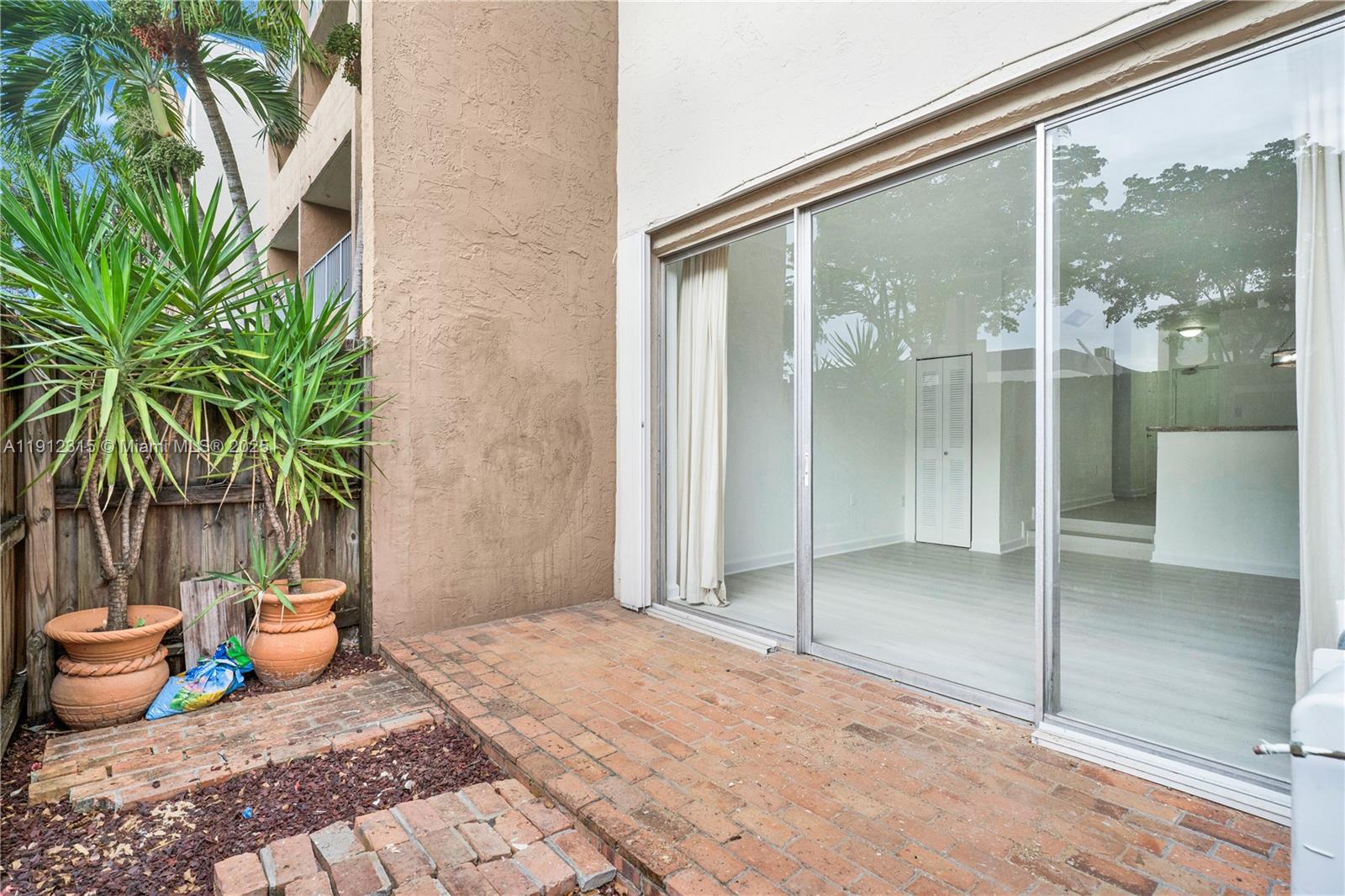 10900 Southwest 104th Street, Unit 121 Miami, FL 33176 - Photo 25 of 34 a porch with a table and chairs
