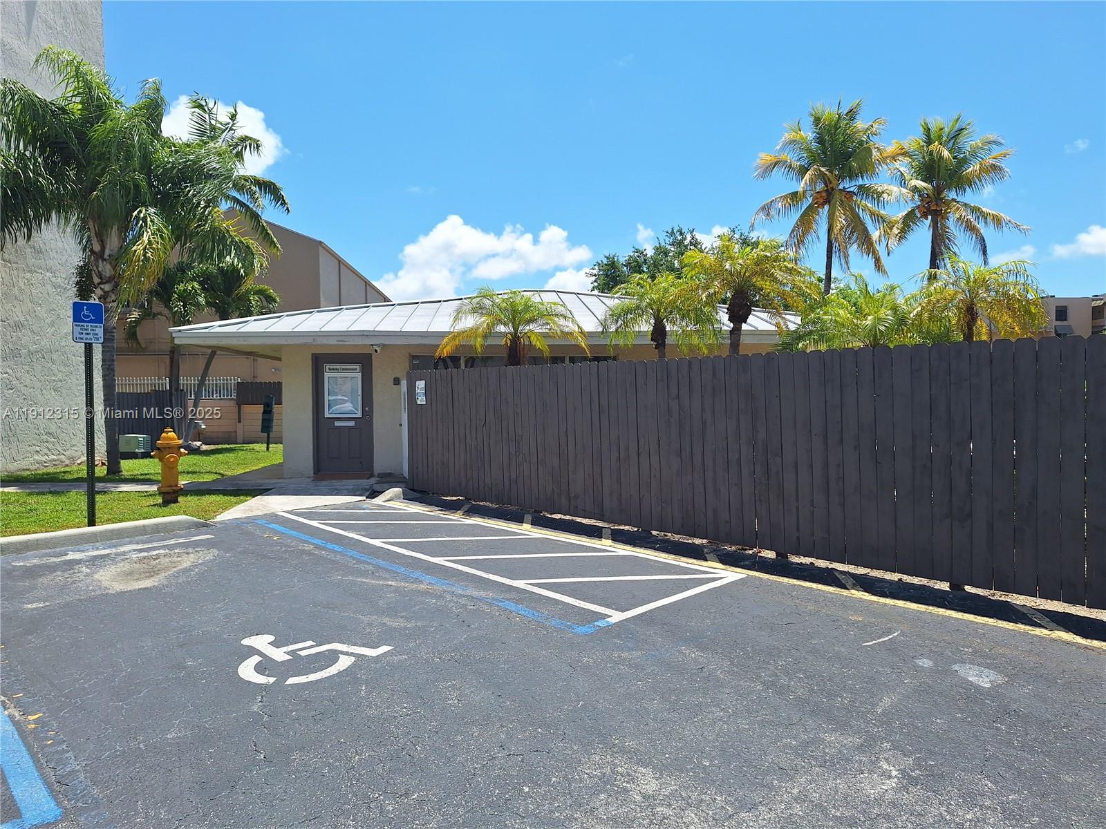 10900 Southwest 104th Street, Unit 121 Miami, FL 33176 - Photo 27 of 34 a backyard of a house with table and chairs potted plants and a palm tree