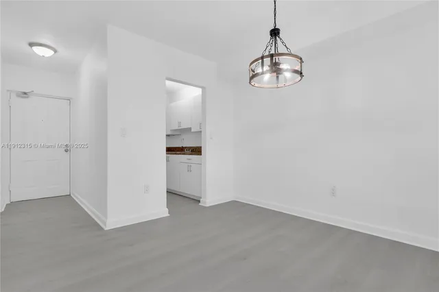 a kitchen with granite countertop white cabinets and a sink