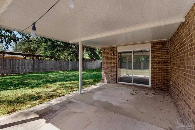 a view of a patio with couches and potted plants