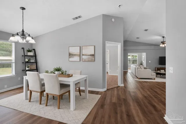 a view of a dining room with furniture and wooden floor
