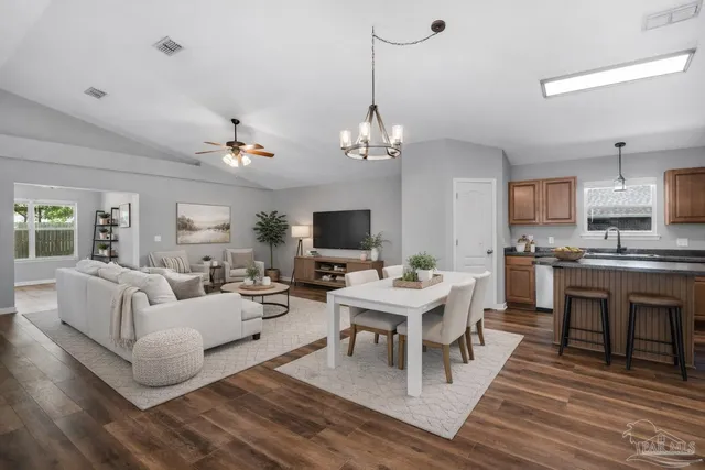 a kitchen with stainless steel appliances granite countertop a refrigerator stove microwave and sink