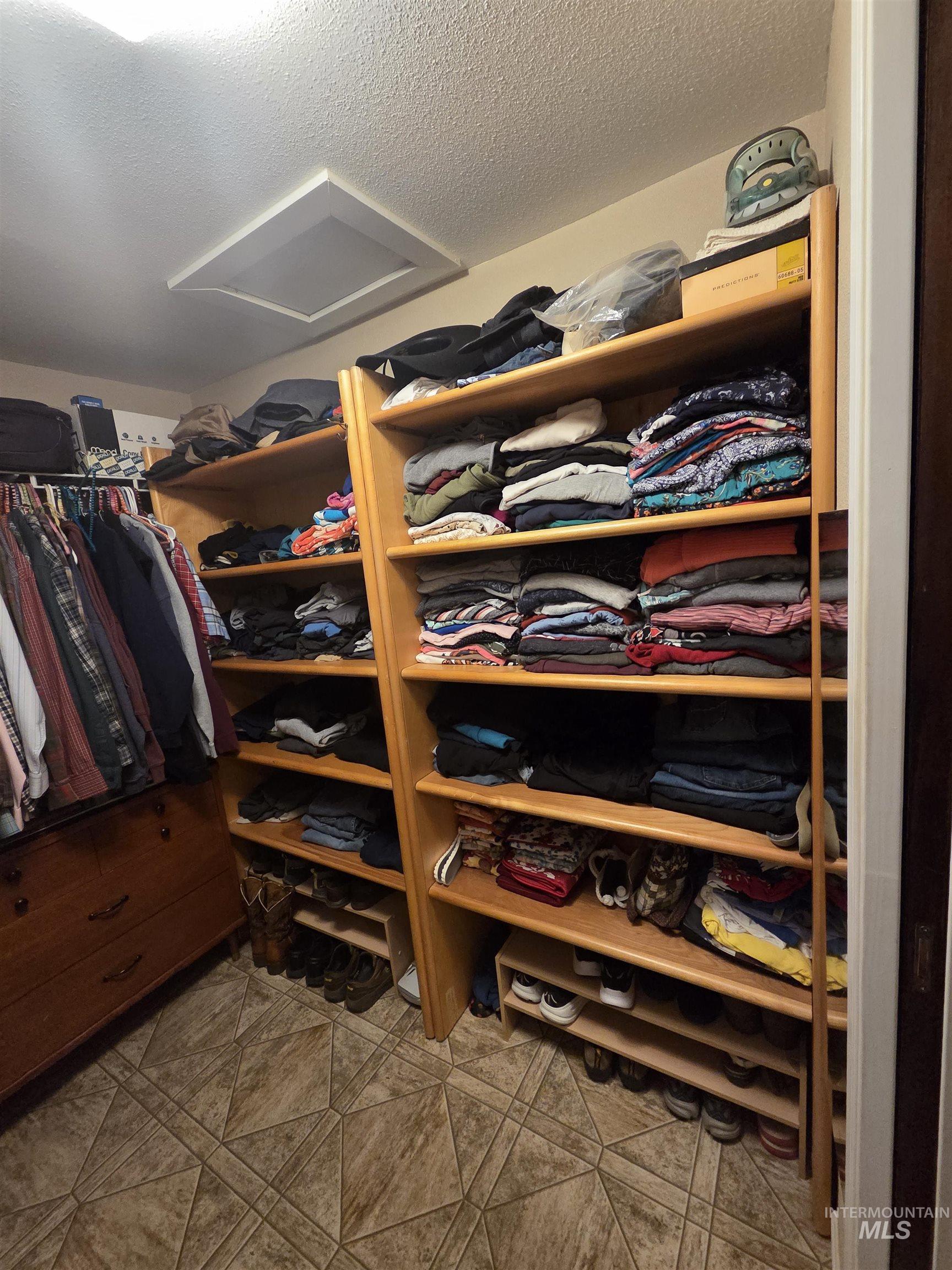 109 South 3rd Street Pomeroy, WA 99347 - Photo 14 of 36 Custom closet system featuring wood-finish shelving and geometric tile flooring