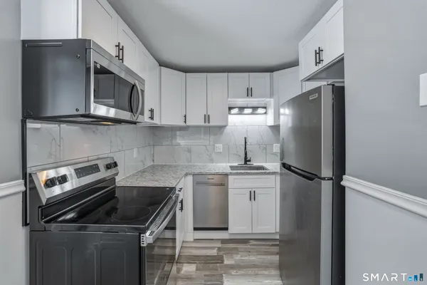 a kitchen with a sink stove and refrigerator