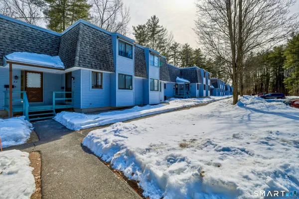 a view of a house with a snow on the road