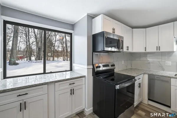 a kitchen with a stove microwave and cabinets