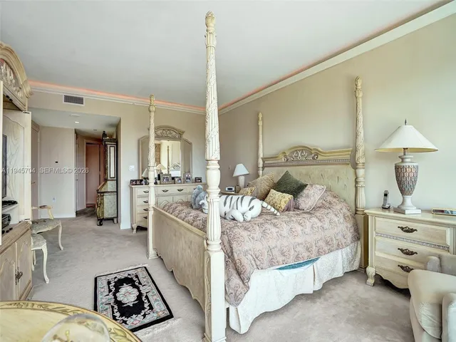 a bedroom with a bed and dresser with mirror